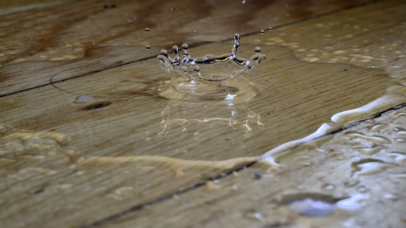 Water pooling and beading on wood plank flooring